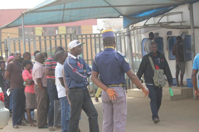 Customers queue to make transactions at ATM gallery